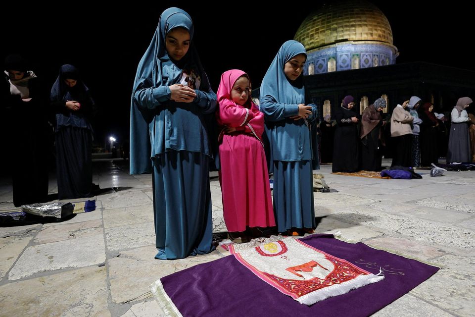 Palestinian worshippers perform prayers by the Dome of the Rock at the beginning of the holy fasting month of Ramadan Photo: Reuters/Ammar Awad