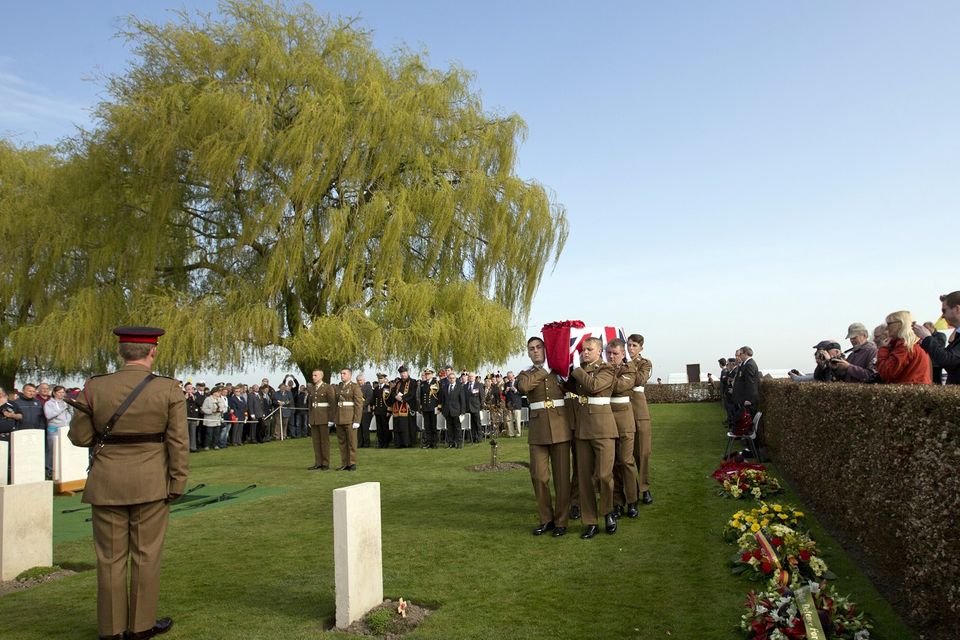 Soldiers carry the casket of a First World War soldier during a reburial ceremony at Prowse Point cemetery in Ploegsteert, Belgium (AP)