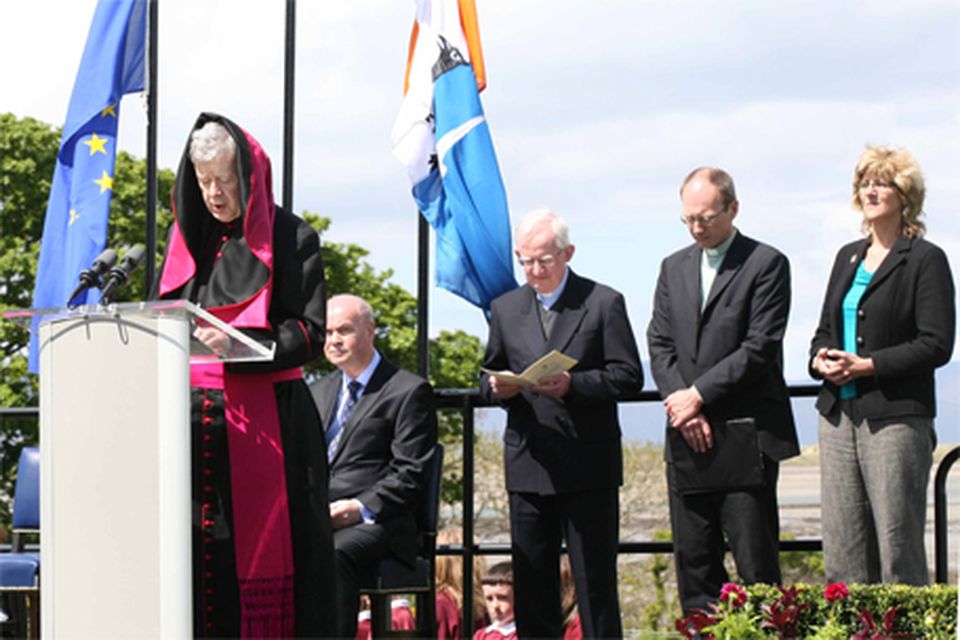 The wind plays a trick on Archbishop Michael Neary as he prays for the victims