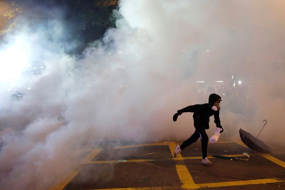 An anti-extradition demonstrator runs away from tear gas, after a march to call for democratic reforms, in Hong Kong
REUTERS/Tyrone Siu