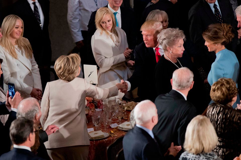 Newly sworn in President Donald Trump with his wife first lady Melania Trump, shakes hands with Hillary Clinton, as they arrive for the inaugural luncheon at the Statuary Hall in the Capitol, Friday, Jan. 20, 2017, in Washington.  (AP Photo/Manuel Balce Ceneta)