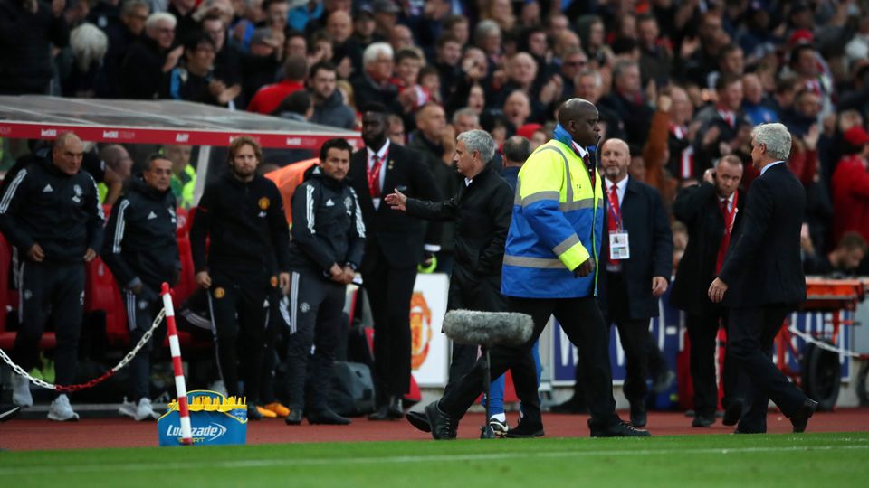 Jose Mourinho, centre, walked away from Mark Hughes, right