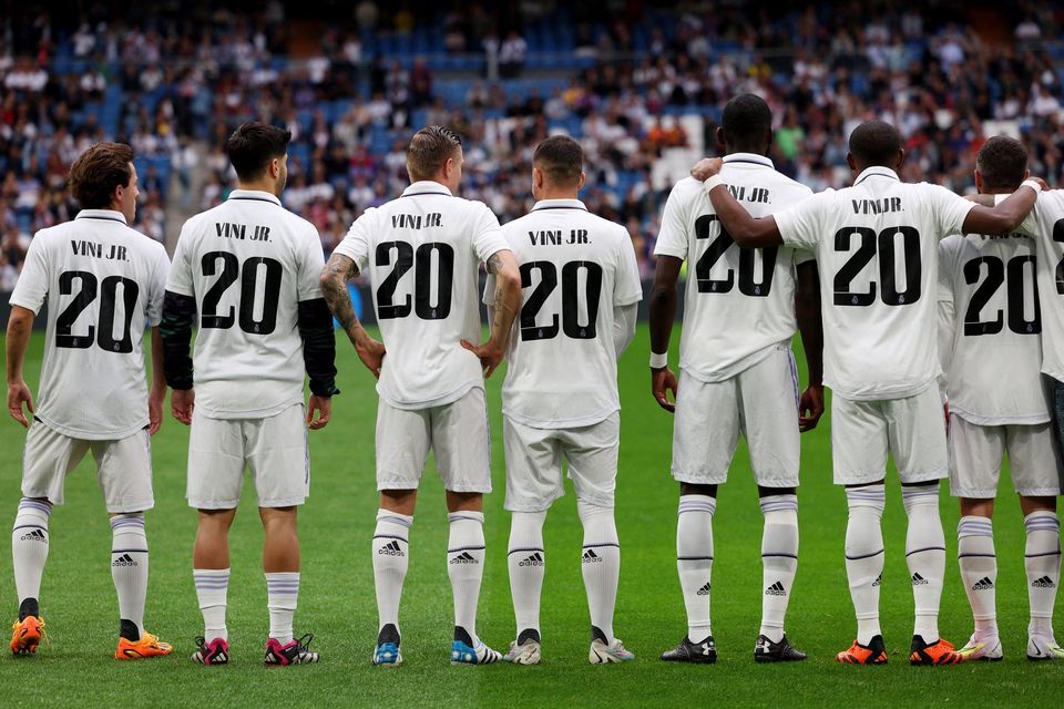 Real Madrid's players wear shirts in support of Vinicius Junior before the match against Rayo Vallecano last night.