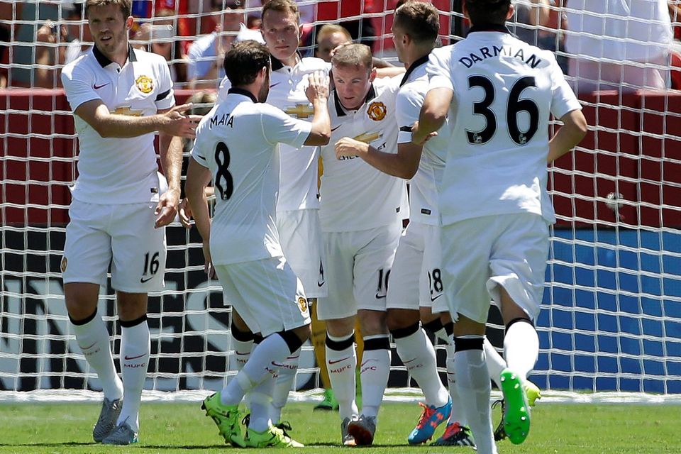 Manchester United's Wayne Rooney, center, celebrates with teammates after scoring a goal against FC Barcelona during the first half of an International Champions Cup soccer match in Santa Clara, Calif., Saturday, July 25, 2015. (AP Photo/Jeff Chiu)