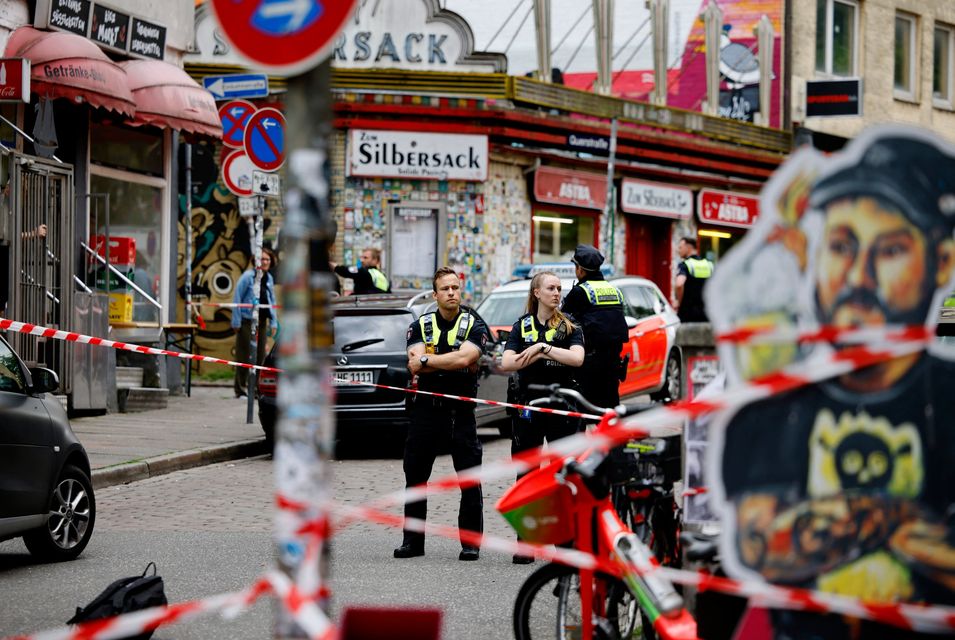 German police officers guard a cordoned off area on Silbersackstrasse after an attacker was shot down by police officers in the St Pauli district of Hamburg, Germany. Photo: Reuters/Axel Schmidt