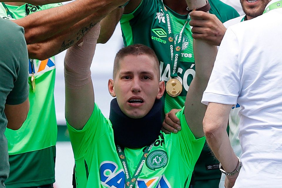 Chapecoense goalkeeper Follmann, one of the three players that survived the air crash, holds up the Sudamericana trophy prior to a friendly match against Palmeiras, in Chapeco, Brazil