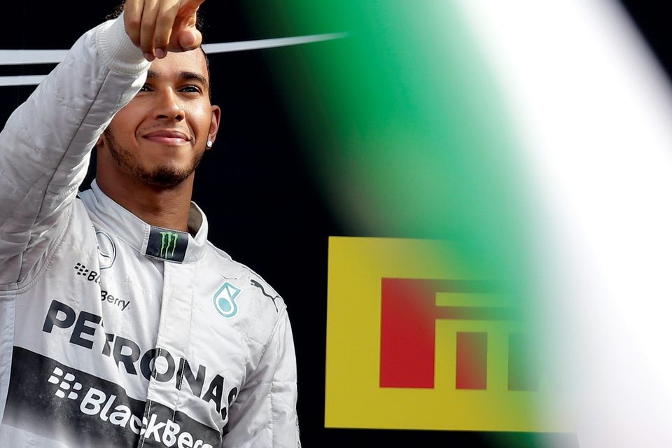 Mercedes Formula One driver Lewis Hamilton of Britain celebrates on the podium after winning the Italian F1 Grand Prix in Monza September 7, 2014: "Thankfully Hamilton and Alonso, artisans as they are at their craft, give us more than enough reasons to follow F1" writes David Kennedy (REUTERS/Max Rossi)