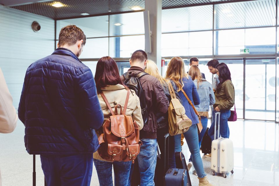 Passengers queue to board an aircraft. Photo: Getty