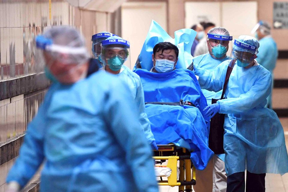 Worry: Medical staff transfer a patient with a suspected case of coronavirus at the Queen Elizabeth Hospital in Hong Kong. Photo: Reuters
