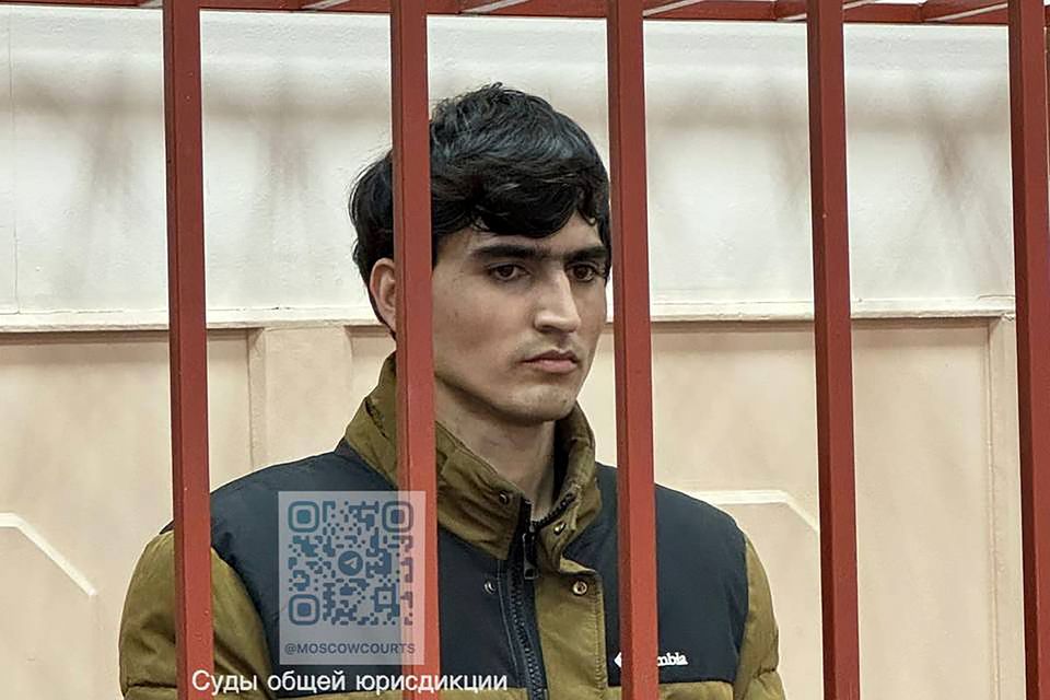 Dzhumokhon Kurbonov, a suspect in the Crocus City Hall shooting, stands in a cage in the Basmanny District Court in Moscow, Russia (Basmanny District Court press service via AP)