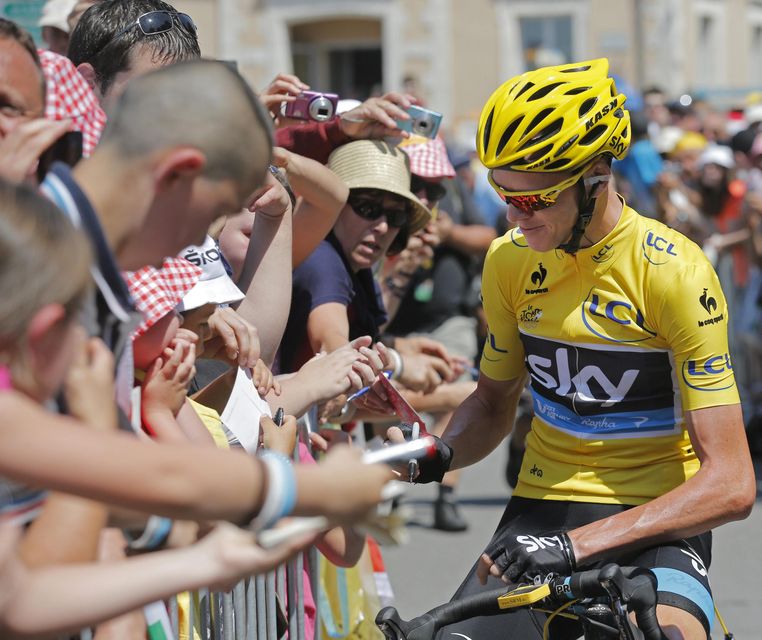 Christopher Froome of Britain, wearing the overall leader's yellow jersey, signs autographs prior to the tenth stage of the Tour de France cycling race over 197km (123.1 miles) with start in in Saint-Gildas-des-Bois and finish in Saint-Malo
