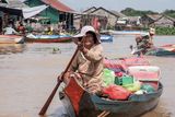 thumbnail: A woman rides her boat selling vegetables and supplies to the residents
