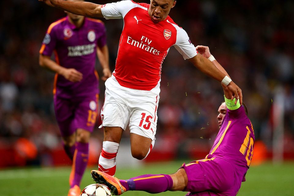 Arsenal's Alex Oxlade-Chamberlain evades a sliding tackle from Galatasaray midfielder Wesley Sneijder during the Champions League game at the Emirates. Photo: Paul Gilham/Getty Images