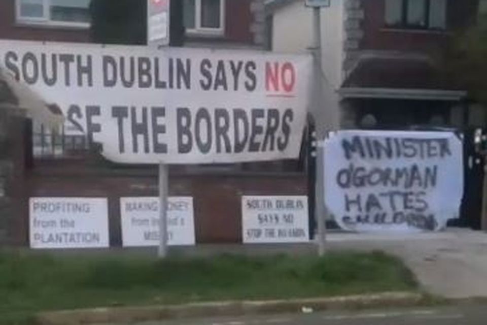 Banners placed on the railings at Minister Roderic O'Gorman's house by masked individuals aligned to the far right