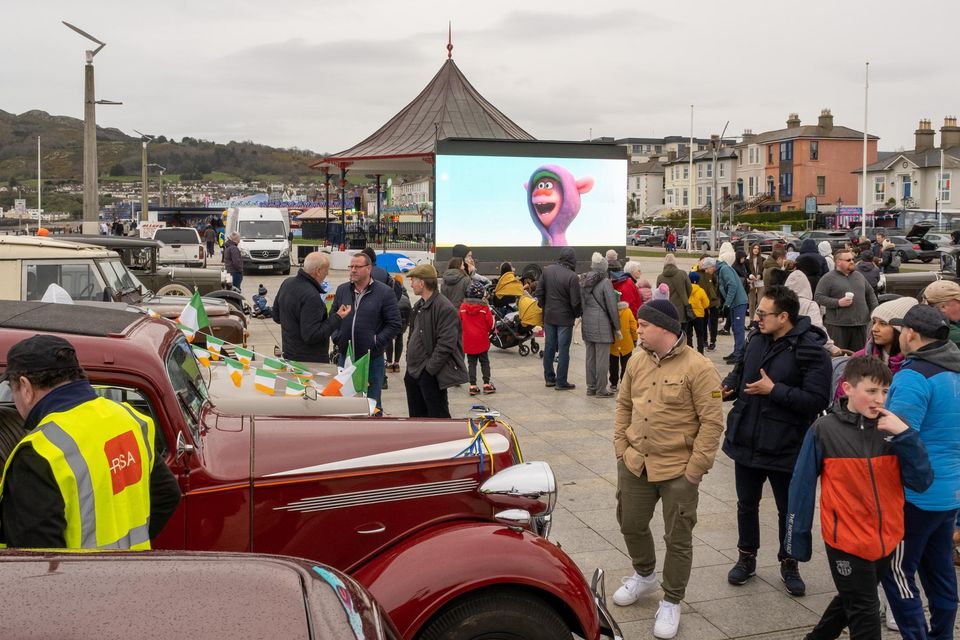 A movie plays on the big screen at the bandstand in Bray with vintage cars also on display.