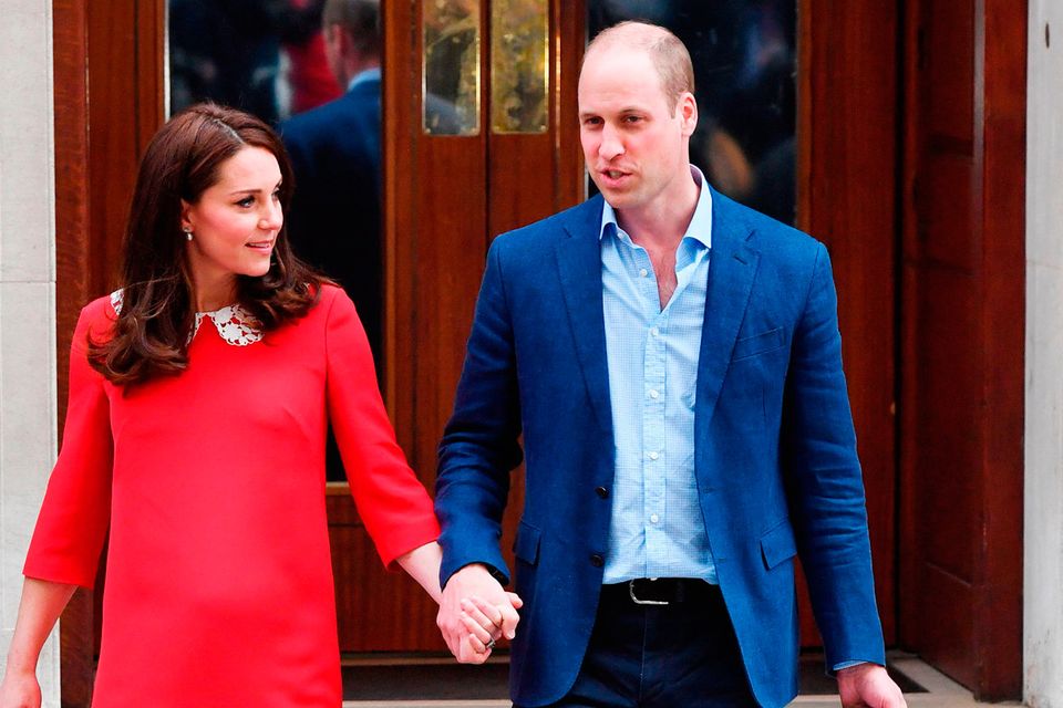 The Duke of Cambridge holds the hand of his wife, the Duchess of Cambridge, as he carries their newborn son from the Lindo Wing at St Mary's Hospital in Paddington, London