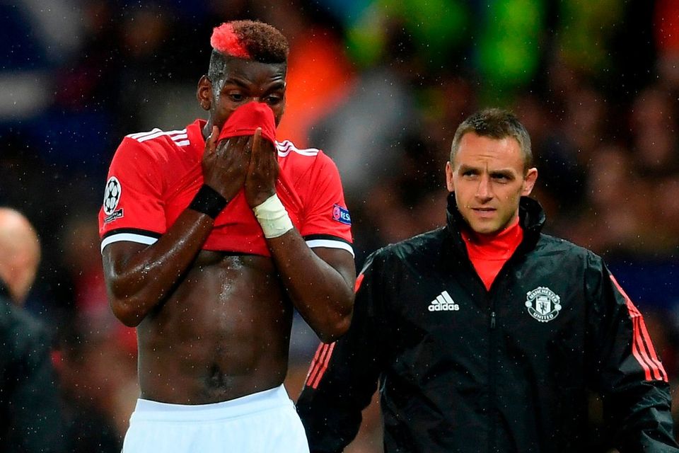 Paul Pogba of ManchesterUnited reacts to being forced off through injury during the UEFA Champions League Group A match between Manchester United and FC Basel at Old Trafford