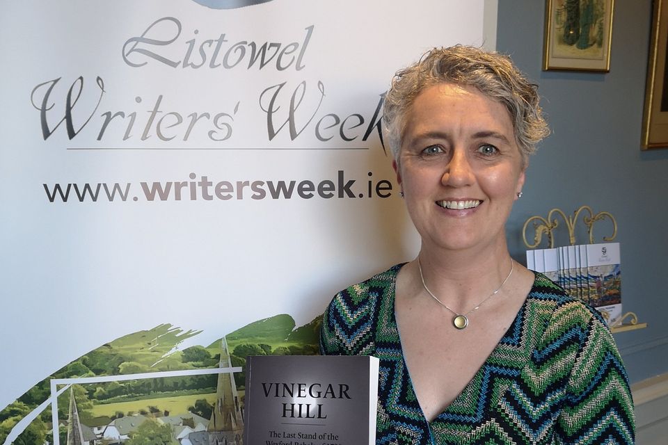 Jacqui Hynes with the book on Vinegar Hill.