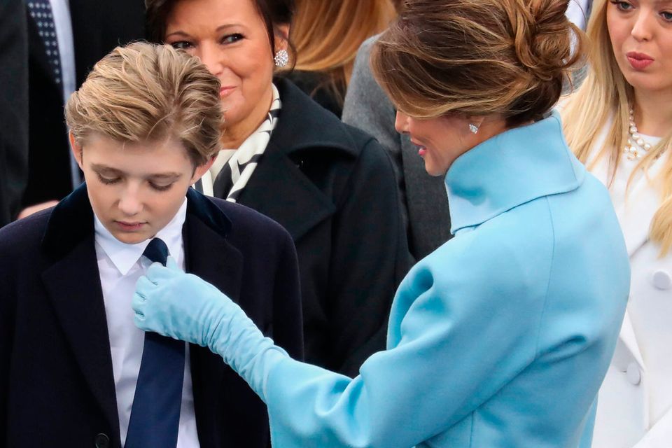 President Donald Trump's wife Melania Trump adjusts their son Barron's tie during the 58th Presidential Inauguration at the U.S. Capitol in Washington, Friday, Jan. 20, 2017. (AP Photo/Andrew Harnik)