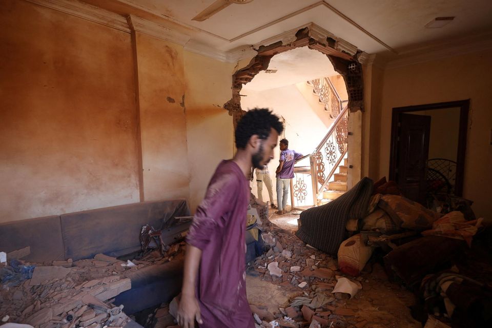 A man looks at the damage inside a house during clashes between the paramilitary Rapid Support Forces and the army in Khartoum, Sudan. Photo: Reuters
