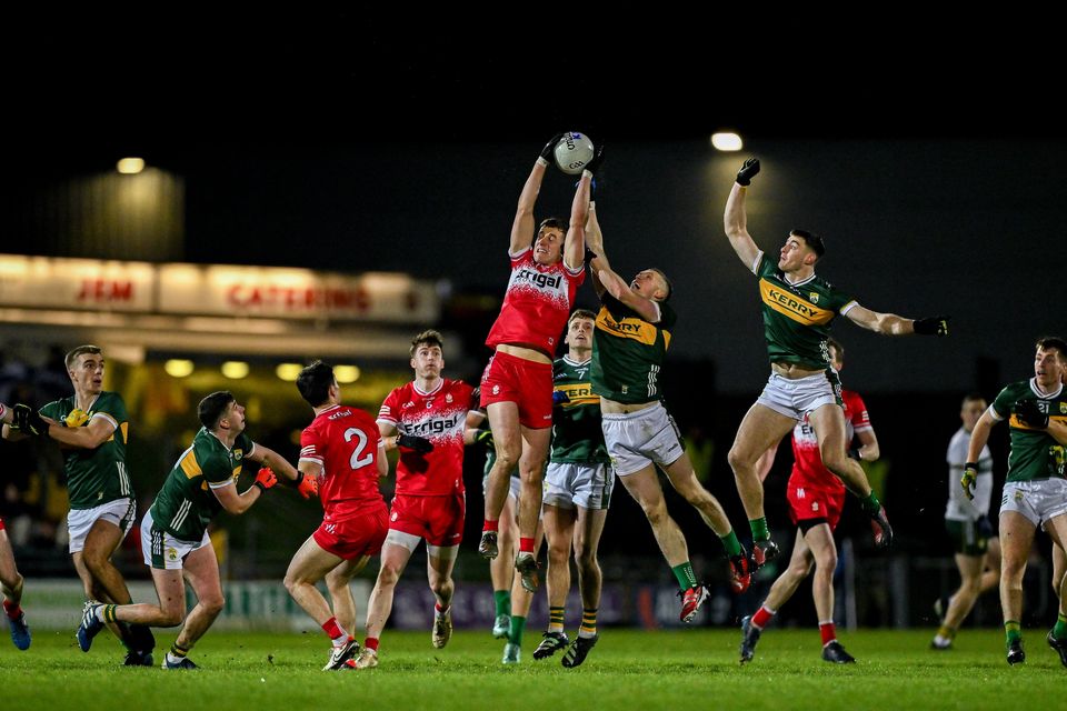 Derry's Shane McGuigan catches a kick-out ahead of Kerry duo Jason Foley and Diarmuid O'Connor. Photo: Brendan Moran/Sportsfile