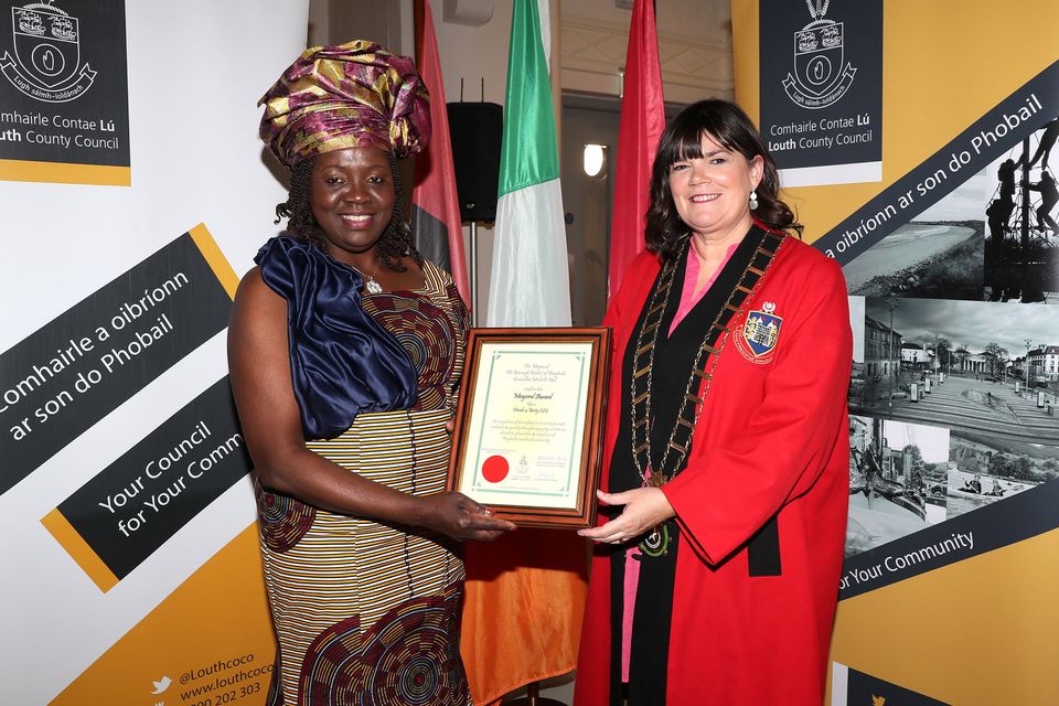 Ejiro Stratton accepts the award on behalf of Hands 4 Unity. 