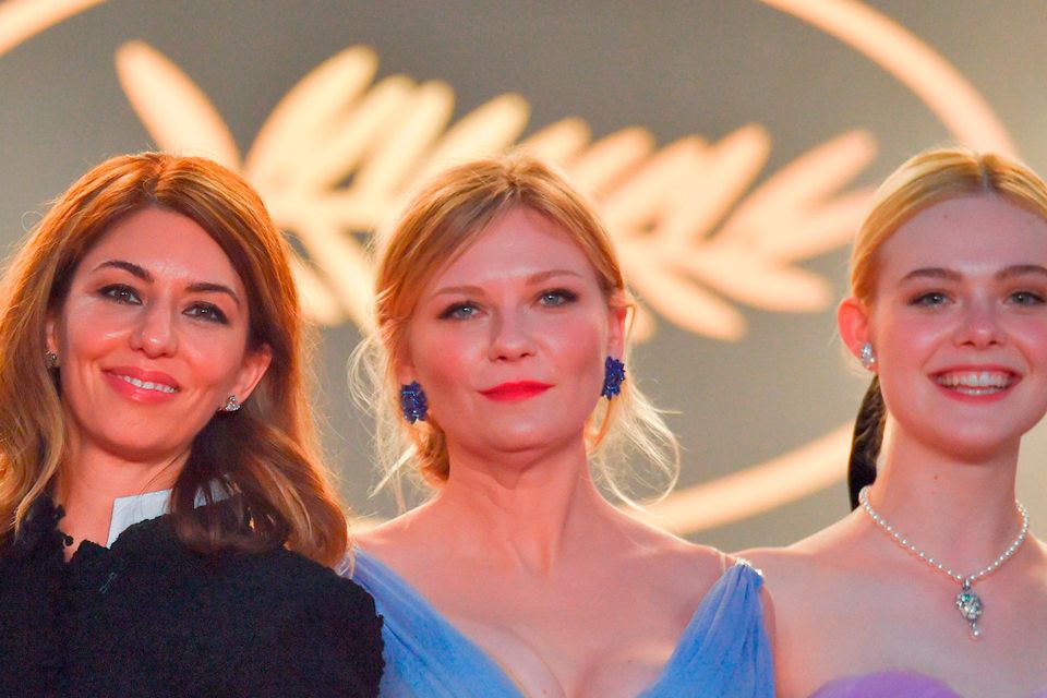 (From L) US director Sofia Coppola, US actress Kirsten Dunst and US actress Elle Fanning pose as they leave on May 24, 2017 following the screening of the film 'The Beguiled' at the 70th edition of the Cannes Film Festival in Cannes, southern France.  / AFP PHOTO / LOIC VENANCELOIC VENANCE/AFP/Getty Images