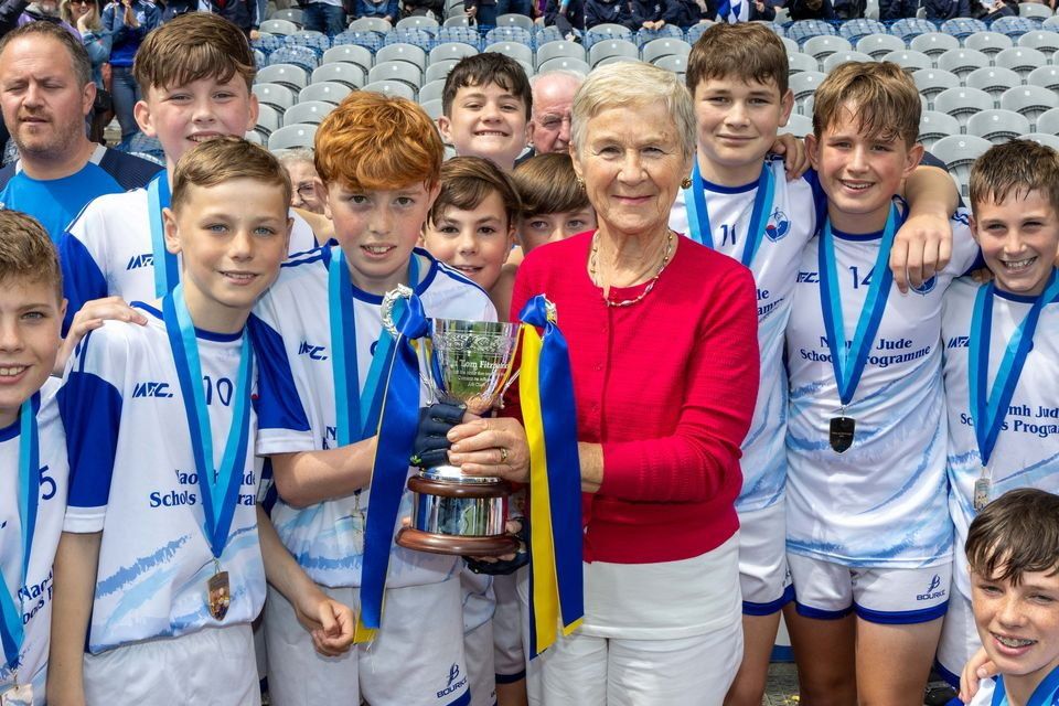 Bishop Galvin, Templeogue captain, Danny Quigley, is presented with the Tom Fitzpatrick Memorial Cup by Tom's sister, Geraldine, at Croke Park.