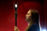 thumbnail: An employee poses with Saruman's staff as Lord of the Rings items from Sir Christopher Lee's collection are displayed at Bonham's in London