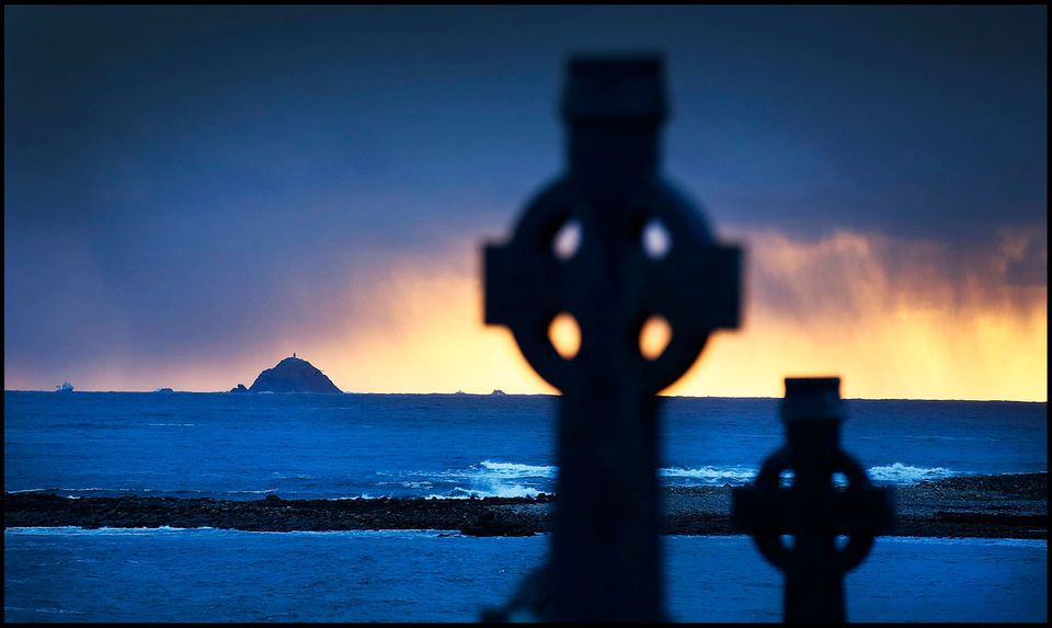 A evening prayer vigil held for the familes and crew of Rescue 116 with Blackrock Lighthouse in the distance near Blacksod Co Mayo Credit: Steve Humphreys