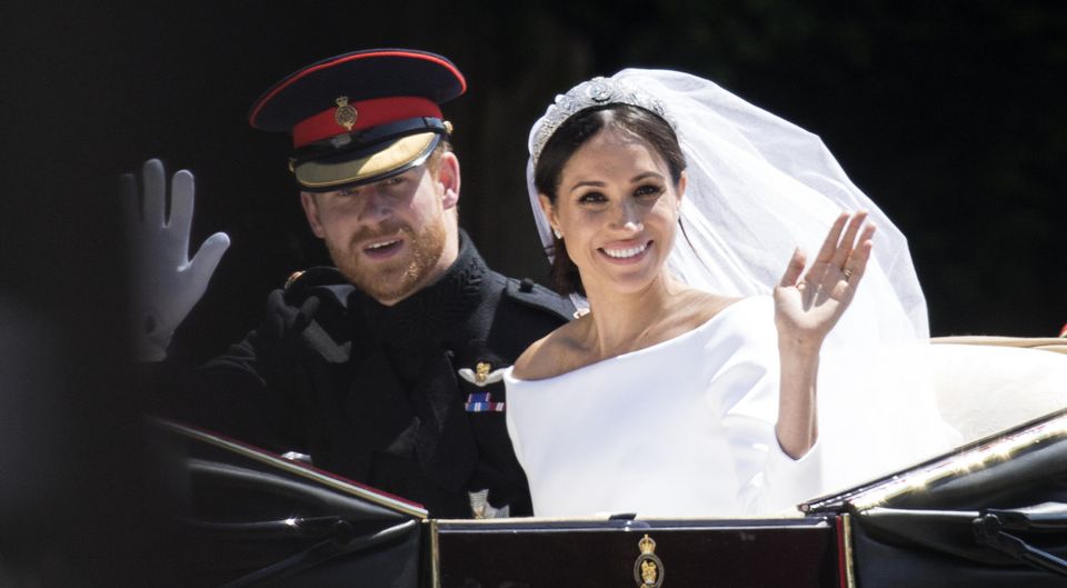 Prince Harry, Duke of Sussex and Meghan, Duchess of Sussex travel in the Ascot Landau Carriage during their carriage procession after their wedding on May 19, 2018 in Windsor, England