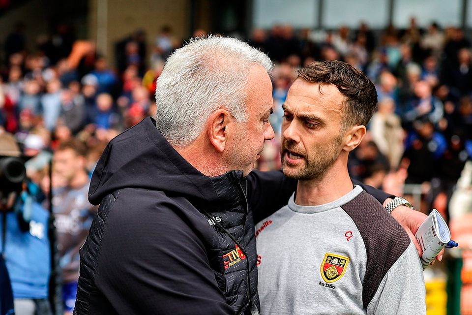 Monaghan manager Gabriel Bannigan, left, and Down manager Conor Laverty shake hands after the match