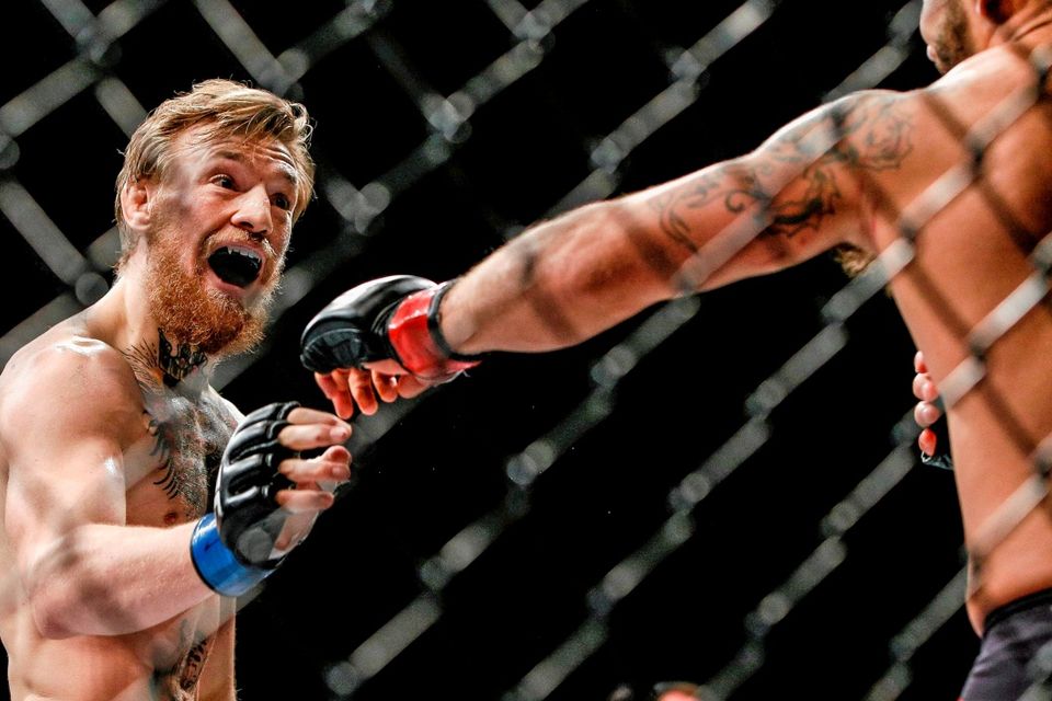 Conor McGregor taunts Chad Mendes during their Interim UFC Featherweight Championship Title bout at UFC 189. MGM Grand Garden Arena, Las Vegas, USA. Photo: Esther Lin / Sportsfile