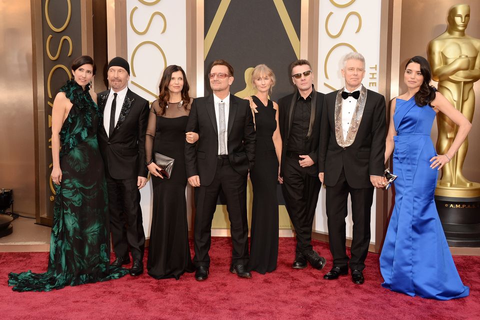 Morleigh Steinberg and The Edge, Alison Hewson and Bono, Ann Acheson and Larry Mullen Jr and Adam Clayton with Mariana Teixeira at the Oscars in 2014. Photo: Getty