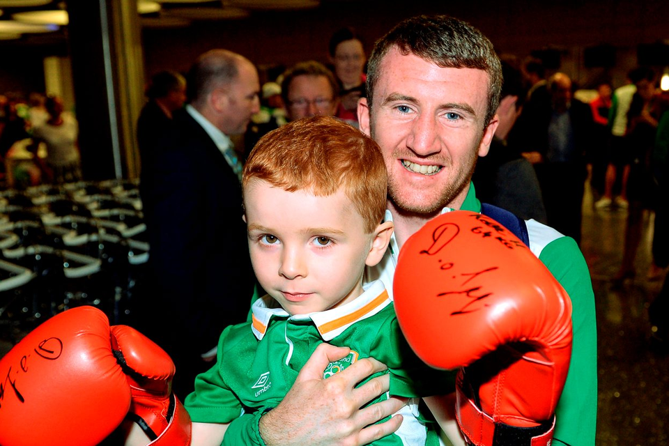 Boxer Paddy Barnes with Joel Thomas (5), from Baldoyle, Co Dublin, at Dublin Airport Photo: Seb Daly/Sportsfile