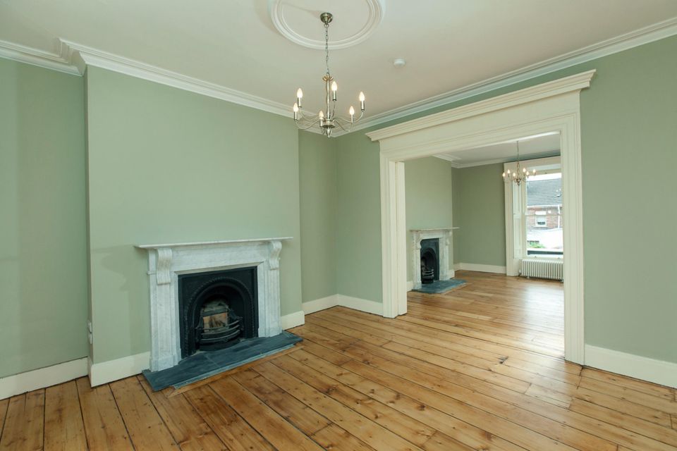 The two main interlinked reception rooms with white marble chimney pieces
