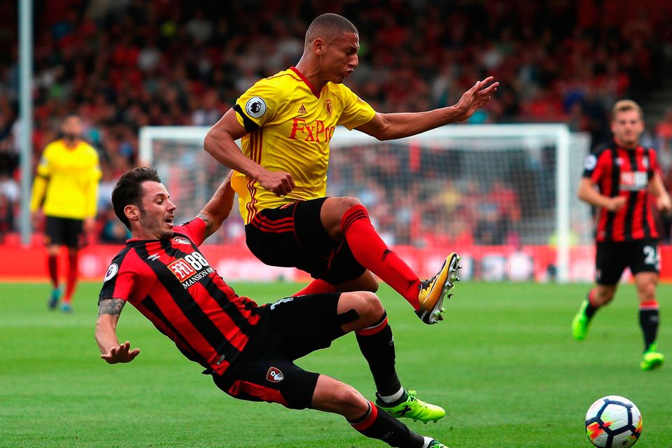 Adam Smith of AFC Bournemouth tackles Richarlison de Andrade of Watford   Photo: Getty