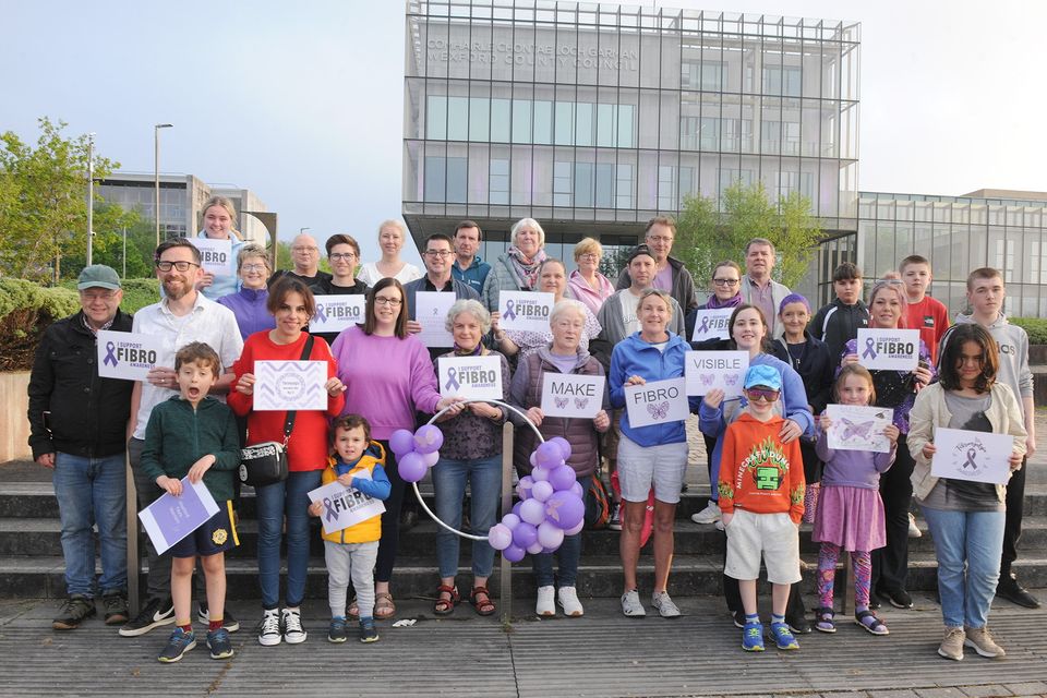Local group fibro-warriors gathered outside the County Hall at Carricklawn on Sunday evening pictured with Cllr Leonard Kelly and local election candidate Michelle O'Neill to mark fibromyalgia awareness day, the council building was also lit up purple. Pic: Jim Campbell