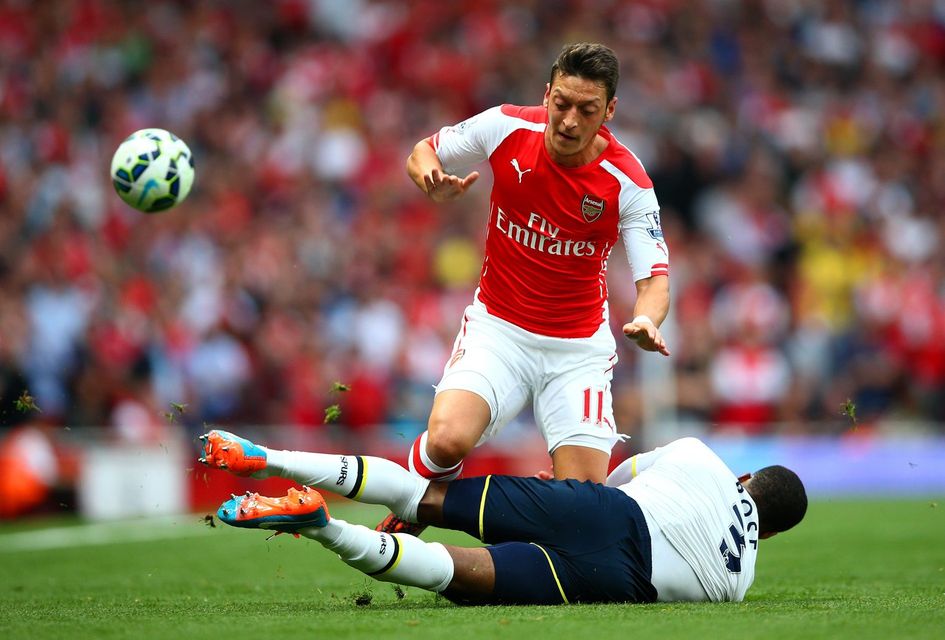 Mesut Oezil in action against Danny Rose. Paul Gilham/Getty Images