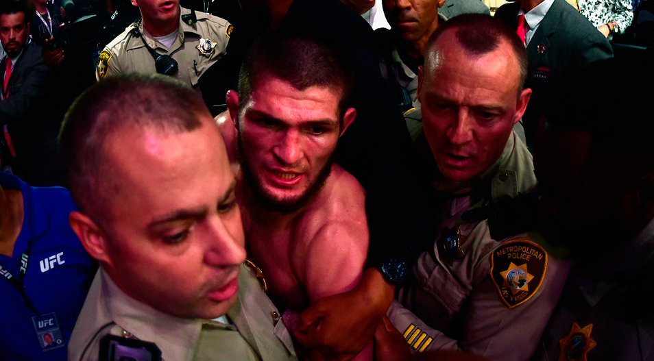 Khabib Nurmagomedov is escorted out of the arena after defeating Conor McGregor