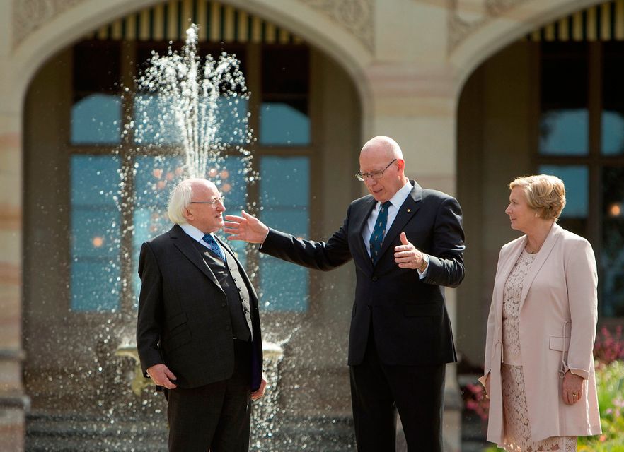 Ireland's President Michael Higgins, left, walks with New South Wales state Governor David Hurley and Deputy Prime Minister of Ireland Frances Fitzgerald, right, on the grounds at Government House in Sydney, Australia, Tuesday, Oct. 17, 2017. (AP Photo/Steve Christo, Pool)