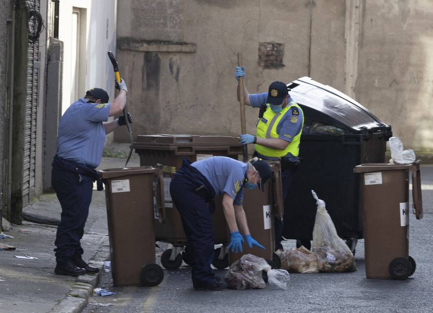 Gardaí searching through bins on Frederick Lane North. Pic: Sam Boal/Collins Photos