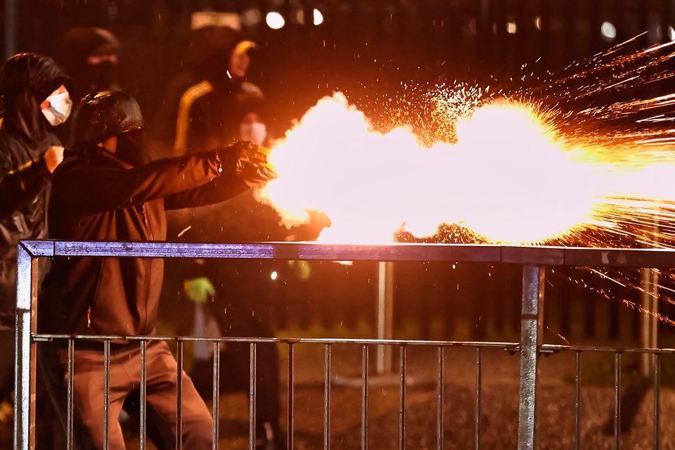 Youths launch fireworks at the PSNI during the protests in Belfast. Photo: Liam McBurney/PA Wire