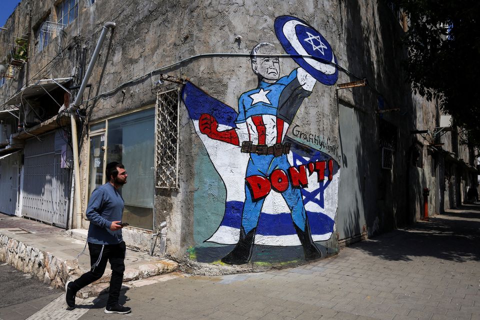 Graffiti in Tel Aviv depicts US president Joe Biden as a superhero. Photo: Reuters