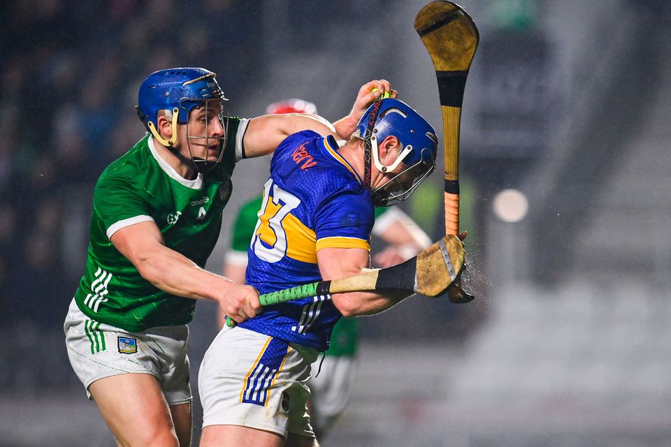 Jason Forde of Tipperary holds off Mike Casey of Limerick on his way to scoring his side's first goal at SuperValu Páirc Uí Chaoimh in Cork. Photo: Seb Daly/Sportsfile