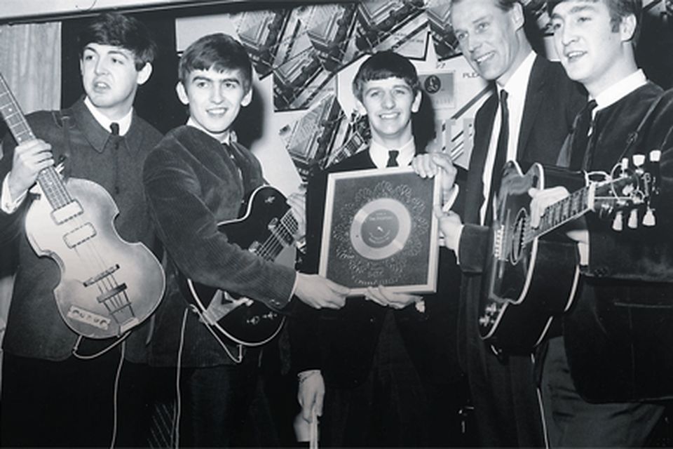 The magic touch:
The Beatles, with
George Martin,
holding their silver
disc for 'Please,
Please Me' in 1963