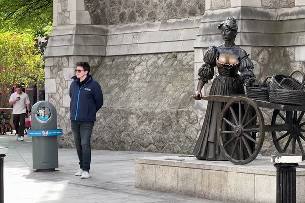 A man in his 20s looks awkwardly around before walking up and tapping the statue of Molly Malone’s left breast. A woman grabs her while mugging for a camera, a teenager jumps up and slaps the chest before hopping down and running off – a sort of drive-by groping.?