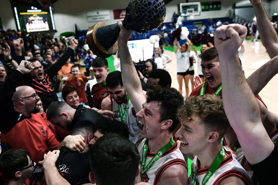 Ballincollig players including captain Adrian O'Sullivan, centre, celebrates with his team-mates and supporters with the trophy after the Super League final. Photo: Ben McShane/Sportsfile