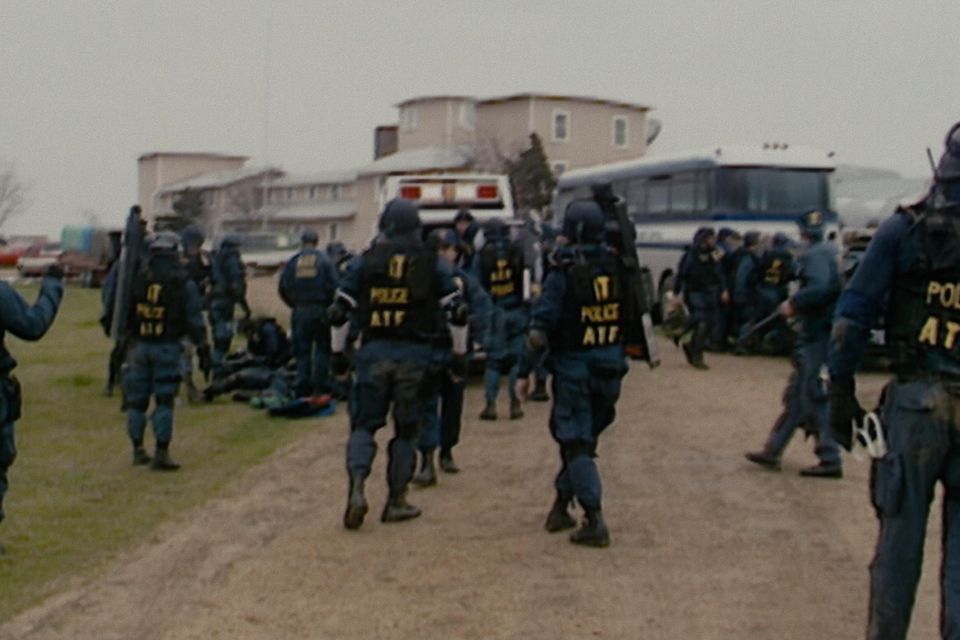 The Bureau of Alcohol, Tobacco and Firearms (ATF) outside the Davidian compound in Waco, Texas before the inferno. Photo courtesy of Netflix