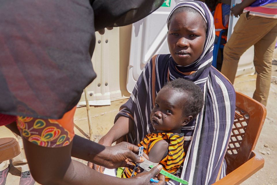 A baby has their arm measured to check for malnutrition at a refugee camp for people who crossed from Sudan, in Renk County, South Sudan. Photo: Peter Louis/WFP via AP